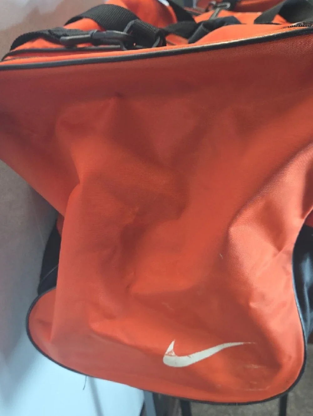 Nike Men’s Orange Duffel Bag with White Swoosh and Black Accents